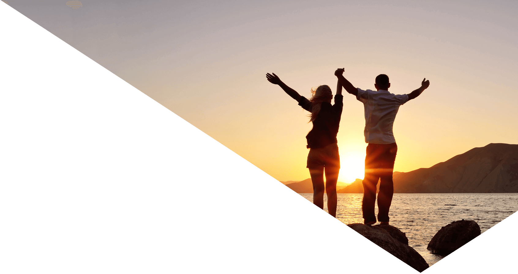 Young couple watching the sun, raising his hands to the sky