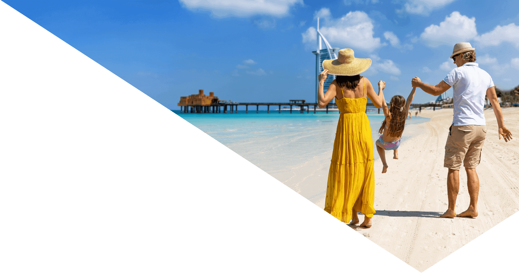 A happy family on summer vacation walks down a beautiful city beach in Dubai, UAE