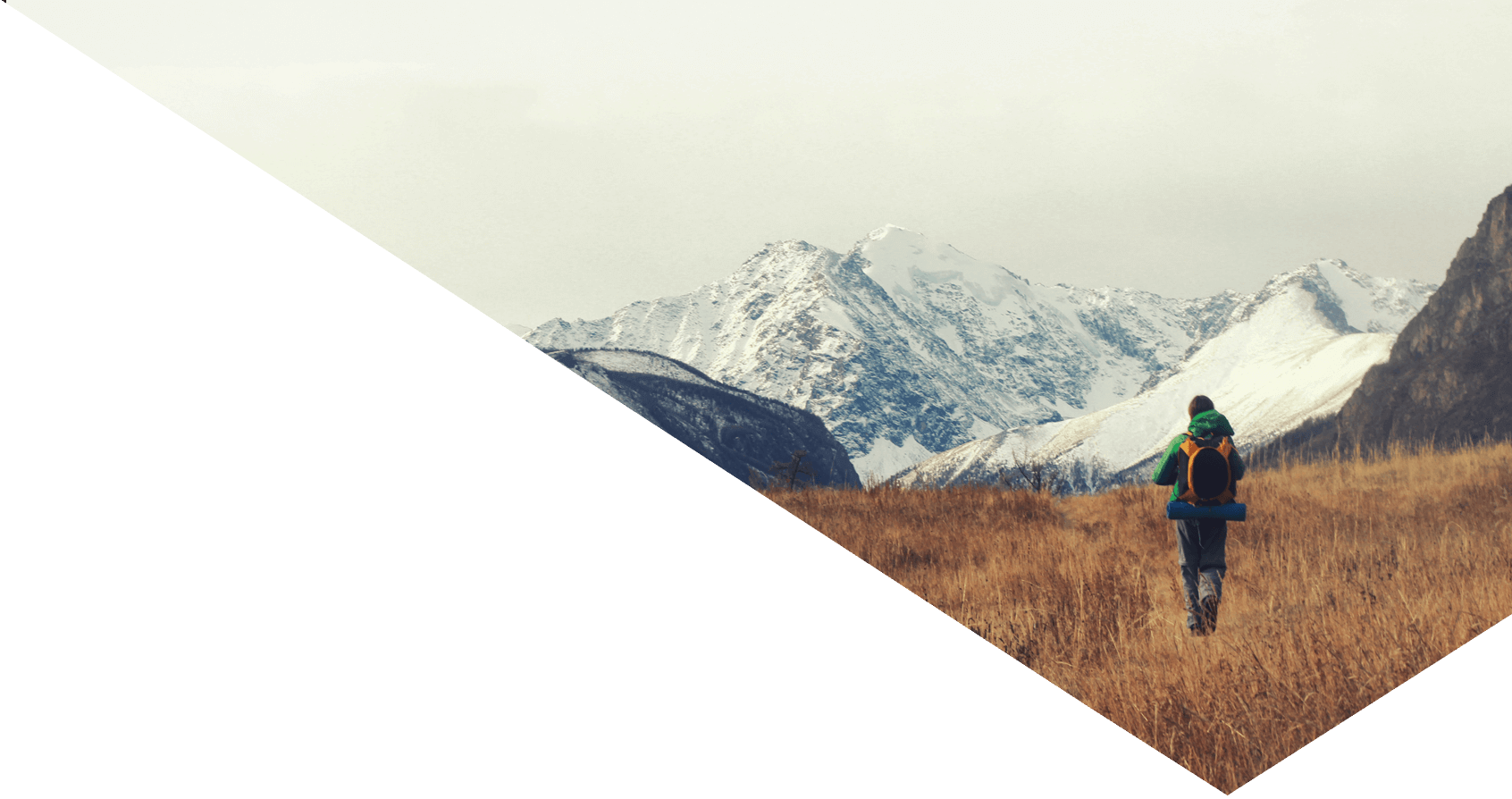 A man hiking with snowy mountain backdrop