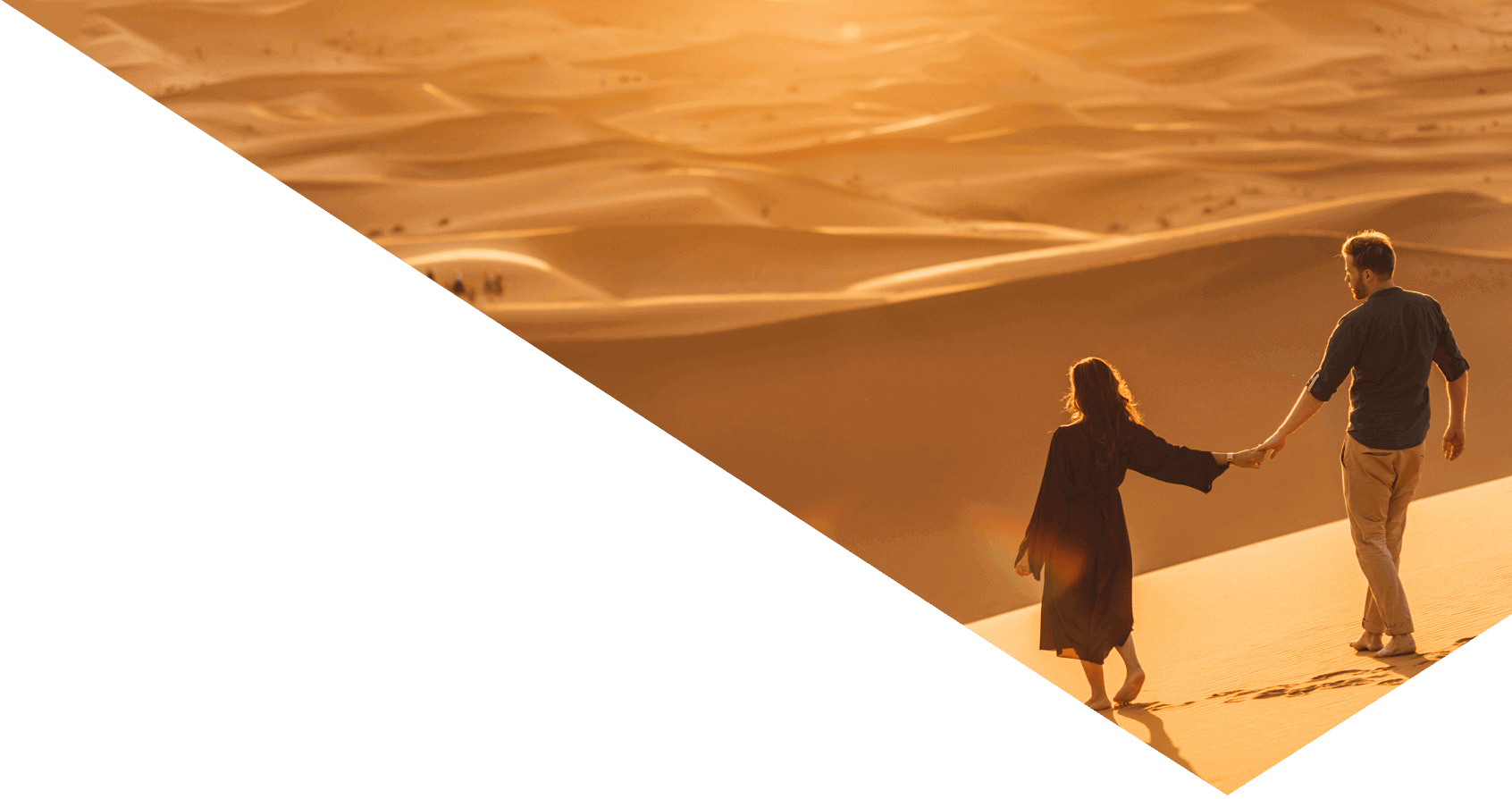 Couple walking in Sahara desert at sunset. View from behind, nature background.