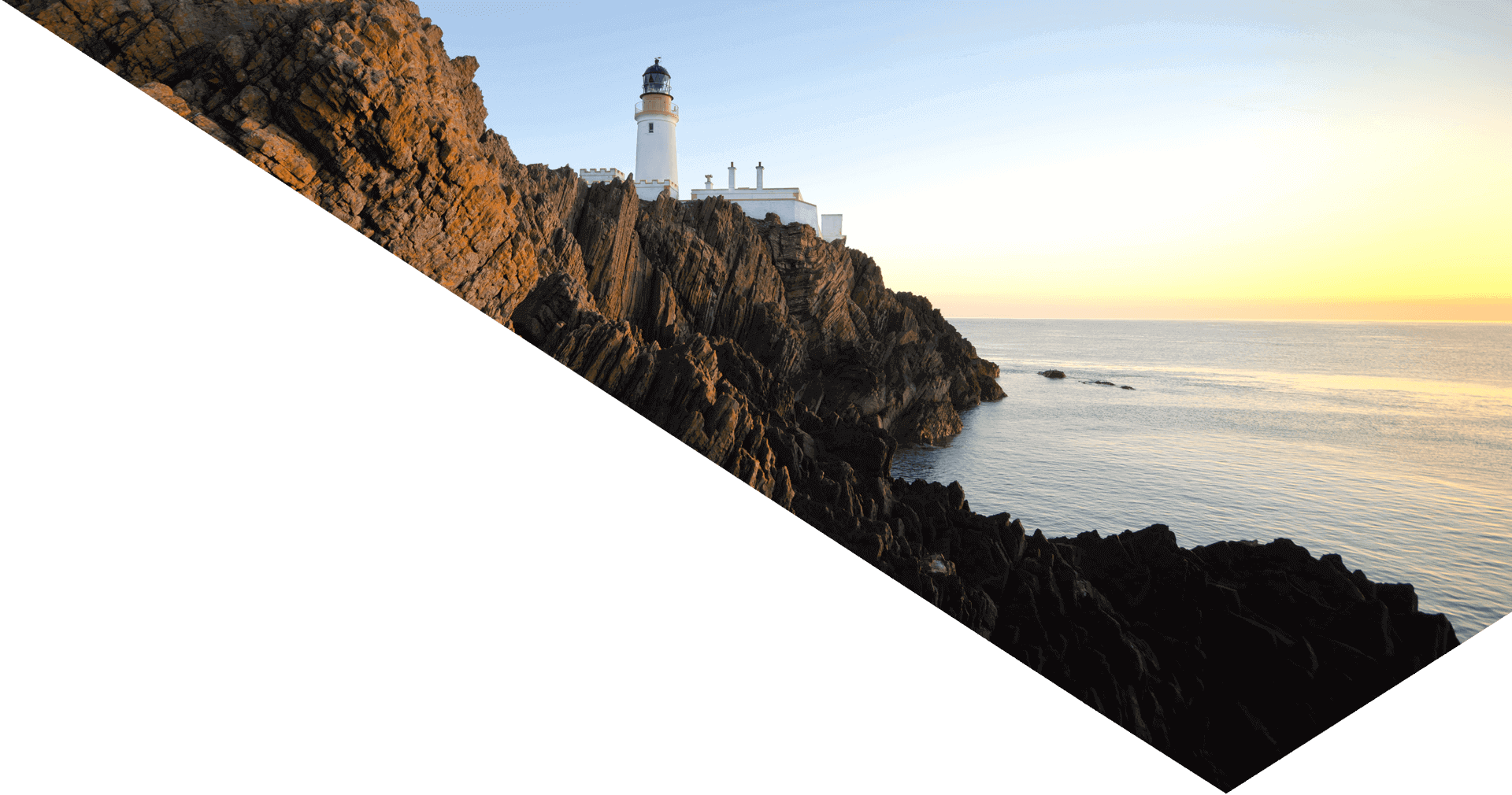 a-hassle-free-relocation-to-the-isle-of-man-header-sunrise-over-douglas-lighthouse-cliffs-on-isle-of-man